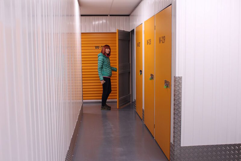 woman wearing green jacket doing self storage